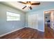 Bedroom featuring wood floors, a window and a double door closet at 11398 88Th Ave, Seminole, FL 33772