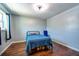 Simple bedroom featuring hardwood floors, a cozy bed and chair near a window at 11398 88Th Ave, Seminole, FL 33772