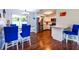 Dining area featuring modern lighting, bright blue chairs and an open view to the kitchen at 11398 88Th Ave, Seminole, FL 33772