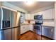 Kitchen features stainless steel appliances, white cabinets, and wood-look floors at 11398 88Th Ave, Seminole, FL 33772