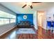 Inviting living room with hardwood floors, a comfy leather sofa, and a brick accent wall at 11398 88Th Ave, Seminole, FL 33772