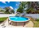 Backyard featuring an above-ground pool with deck and lounge area, perfect for summer fun at 11398 88Th Ave, Seminole, FL 33772