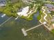 An aerial view featuring a community dock and boat storage area, nestled in a scenic waterfront community at 1242 Windy Bay Shl, Tarpon Springs, FL 34689
