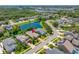Aerial view of the neighborhood displays houses and a pond, indicative of Gathering living and outdoor activities at 1242 Windy Bay Shl, Tarpon Springs, FL 34689