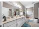 Bathroom featuring double sinks, a spacious shower with glass doors, and a neutral color palette at 1242 Windy Bay Shl, Tarpon Springs, FL 34689