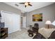 Relaxing bedroom with a comfortable chair and ottoman next to a TV and closet at 1242 Windy Bay Shl, Tarpon Springs, FL 34689