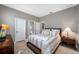 Comfortable bedroom with neutral tones, a cozy bed, and ample natural light from a window at 1242 Windy Bay Shl, Tarpon Springs, FL 34689