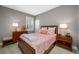 Charming bedroom featuring a cozy bed, bedside tables, and ample natural light from the window at 1242 Windy Bay Shl, Tarpon Springs, FL 34689