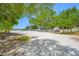 Wide shot of the boat storage lot featuring ample boat parking surrounded by shady trees, creating an idyllic location at 1242 Windy Bay Shl, Tarpon Springs, FL 34689
