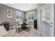 Cozy dining area with a modern table, surrounded by bright windows and elegant decor at 1242 Windy Bay Shl, Tarpon Springs, FL 34689