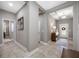 Inviting foyer with neutral tones, tile flooring, decorative lighting, and a view of the front door at 1242 Windy Bay Shl, Tarpon Springs, FL 34689