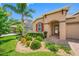 Close up of a well maintained front yard with colorful landscaping and a brick-paved driveway at 1242 Windy Bay Shl, Tarpon Springs, FL 34689