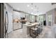 Modern kitchen with white cabinets, stainless steel appliances, a large island, and pendant lighting at 1242 Windy Bay Shl, Tarpon Springs, FL 34689