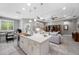 Open kitchen with a large island, stainless steel appliances, and seamless flow into living area at 1242 Windy Bay Shl, Tarpon Springs, FL 34689