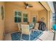 Covered lanai with comfortable seating, ceiling fan, and a view of the pool and backyard at 1242 Windy Bay Shl, Tarpon Springs, FL 34689
