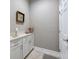 Well-lit laundry room with white cabinets, a countertop, and tile flooring at 1242 Windy Bay Shl, Tarpon Springs, FL 34689
