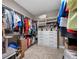 Spacious walk-in closet features built-in shelving and drawer units for optimal organization at 1242 Windy Bay Shl, Tarpon Springs, FL 34689