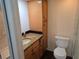 Cozy bathroom featuring granite countertops, wooden cabinets, and a walk-in shower at 1281 Pine Ridge E Cir # B1, Tarpon Springs, FL 34688