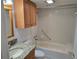 Bathroom featuring granite vanity, wood cabinets, toilet, and shower and tub combo at 1281 Pine Ridge E Cir # B1, Tarpon Springs, FL 34688