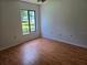 Bright and airy bedroom with hardwood floors, offering comfort and natural light at 1281 Pine Ridge E Cir # B1, Tarpon Springs, FL 34688