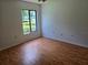 Bright and airy bedroom with hardwood floors, offering comfort and natural light at 1281 Pine Ridge E Cir # B1, Tarpon Springs, FL 34688