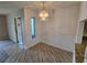 Bright dining room featuring laminate wood flooring and a modern glass chandelier at 1281 Pine Ridge E Cir # B1, Tarpon Springs, FL 34688