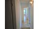Hallway with wood look flooring, and a glimpse of a room with a window and lots of natural light at 1281 Pine Ridge E Cir # B1, Tarpon Springs, FL 34688