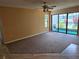 Spacious living room with sliding glass doors leading to an outdoor area with water view at 1281 Pine Ridge E Cir # B1, Tarpon Springs, FL 34688