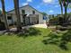 Community pool house surrounded by lush landscaping and palm trees at 1281 Pine Ridge E Cir # B1, Tarpon Springs, FL 34688