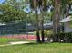 Enjoy a match on this well-maintained tennis court surrounded by lush greenery and mature palms at 1281 Pine Ridge E Cir # B1, Tarpon Springs, FL 34688