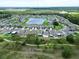 Wide angle aerial view of a suburban community with a central lake at 12835 Wildflower Meadow Dr, Riverview, FL 33579