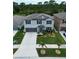 Aerial view of a two-story home with a well-kept lawn and mature palm trees at 12835 Wildflower Meadow Dr, Riverview, FL 33579