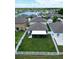Aerial of fenced backyard, featuring a covered patio, grassy area, and white vinyl fence at 12835 Wildflower Meadow Dr, Riverview, FL 33579