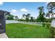 Expansive backyard with lush green lawn and a white picket fence at 12835 Wildflower Meadow Dr, Riverview, FL 33579
