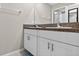 Bathroom with double sink vanity with white cabinets and granite counters at 12835 Wildflower Meadow Dr, Riverview, FL 33579
