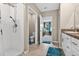 Bathroom featuring tiled shower, toilet and a view into the bedroom at 12835 Wildflower Meadow Dr, Riverview, FL 33579