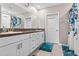 Bathroom with double sink vanity with white cabinets and granite counters and tile floor at 12835 Wildflower Meadow Dr, Riverview, FL 33579