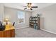 Bedroom with a ceiling fan, window, desk, and a bookshelf at 12835 Wildflower Meadow Dr, Riverview, FL 33579