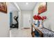 Inviting entryway with a console table, tiled flooring, and a view of exercise equipment at 12835 Wildflower Meadow Dr, Riverview, FL 33579