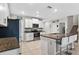 Bright kitchen featuring stainless steel appliances, a center island, and sleek white cabinetry at 12835 Wildflower Meadow Dr, Riverview, FL 33579