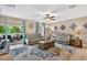 Bright living room with tile floors, two sofas, ceiling fan and access to the outdoor patio at 12835 Wildflower Meadow Dr, Riverview, FL 33579
