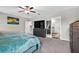 Spacious bedroom with carpeting, a comfortable bed, and an ensuite bathroom at 12835 Wildflower Meadow Dr, Riverview, FL 33579