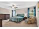 Serene main bedroom with plush carpeting, a comfortable bed, and ample natural light at 12835 Wildflower Meadow Dr, Riverview, FL 33579