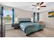 Comfortable bedroom featuring carpeting, a large bed, and a view of the outdoors at 12835 Wildflower Meadow Dr, Riverview, FL 33579