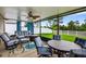 Covered patio featuring comfortable seating, ceiling fan, and views of the fenced yard at 12835 Wildflower Meadow Dr, Riverview, FL 33579
