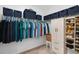 Organized walk-in closet featuring shelving, hanging rods and cabinets for maximum storage at 12835 Wildflower Meadow Dr, Riverview, FL 33579