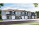 Modern townhomes featuring attached garages, neutral paint scheme, and minimalist landscaping at 131 Mangrove Shade Cir, Apollo Beach, FL 33572