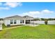 Well-maintained backyard showcasing a screened porch and lush lawn at 13111 Fruitville Way, Riverview, FL 33579