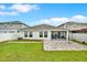 Well-maintained backyard showcasing a screened porch and lush lawn at 13111 Fruitville Way, Riverview, FL 33579