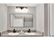 Bathroom featuring a double sink vanity, granite countertop, and framed vanity mirror at 13111 Fruitville Way, Riverview, FL 33579